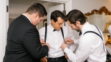 groomsmen helping groom get ready