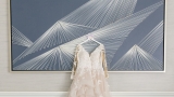 wedding dress in front of art print